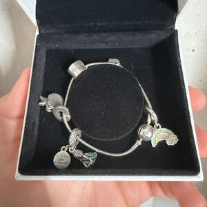 Silver Pandora Charm Bracelet with 7 charms included.
